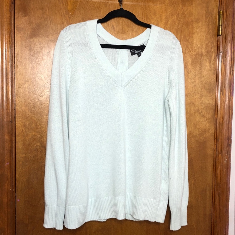 Light blue sweater. Button down back. Size L.